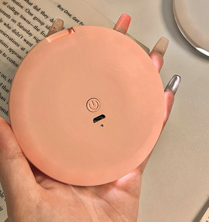 Espejo cosmético portátil con luz LED para maquillaje.